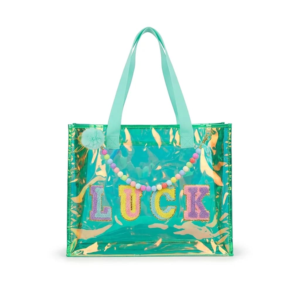 Mint holographic tote bag with the word LUCK in glitter letters, a bead strap and a pom-pom